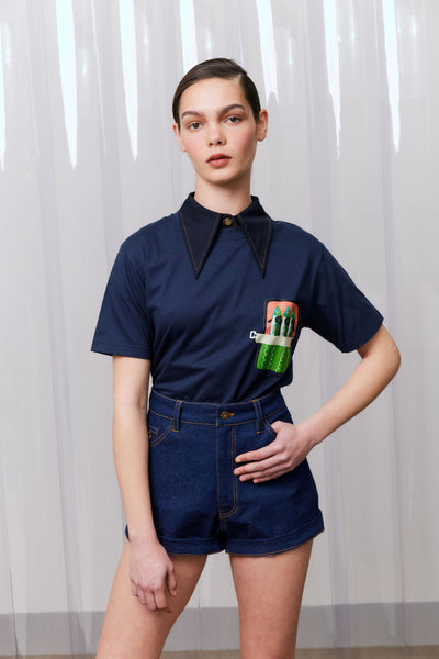 Person wearing a navy blue outfit with a unique design on a white background