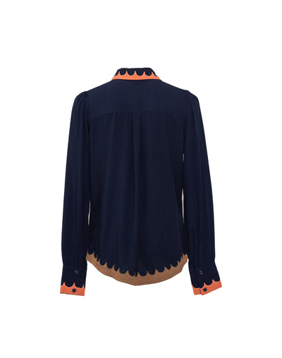 Back view of A classic button-up shirt with scalloped edging, and a wing collar, in navy and coral colors.