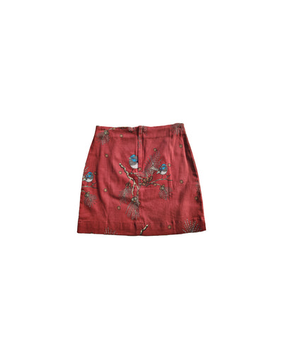 Red skirt with a bird pattern on a white background