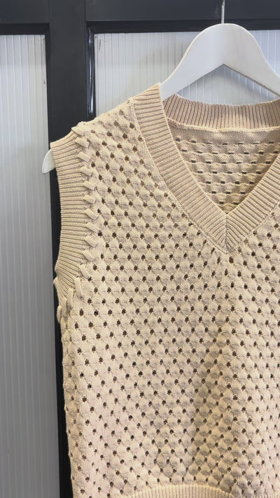 video of a beige knitted vest on a hanger